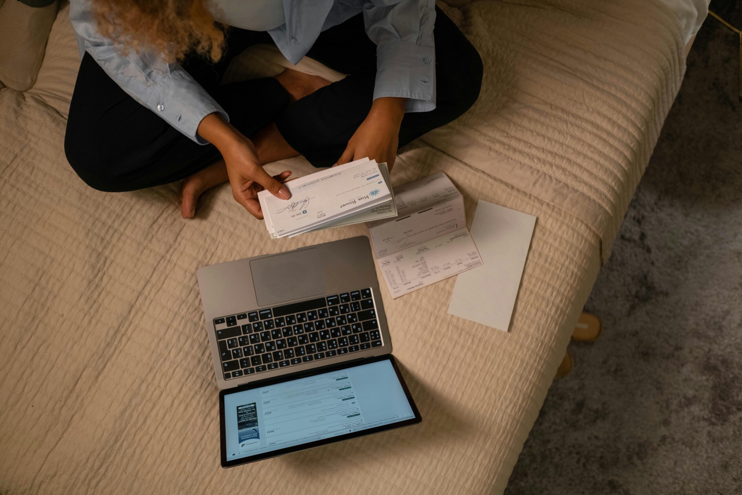 Woman working on a laptop reviewing checking account information