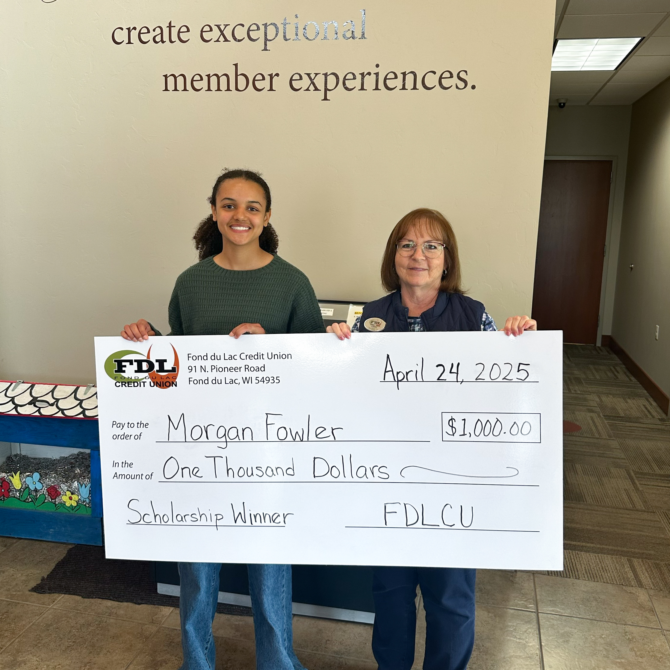 fdlcu-14 2023 Scholarship Winner holding giant check